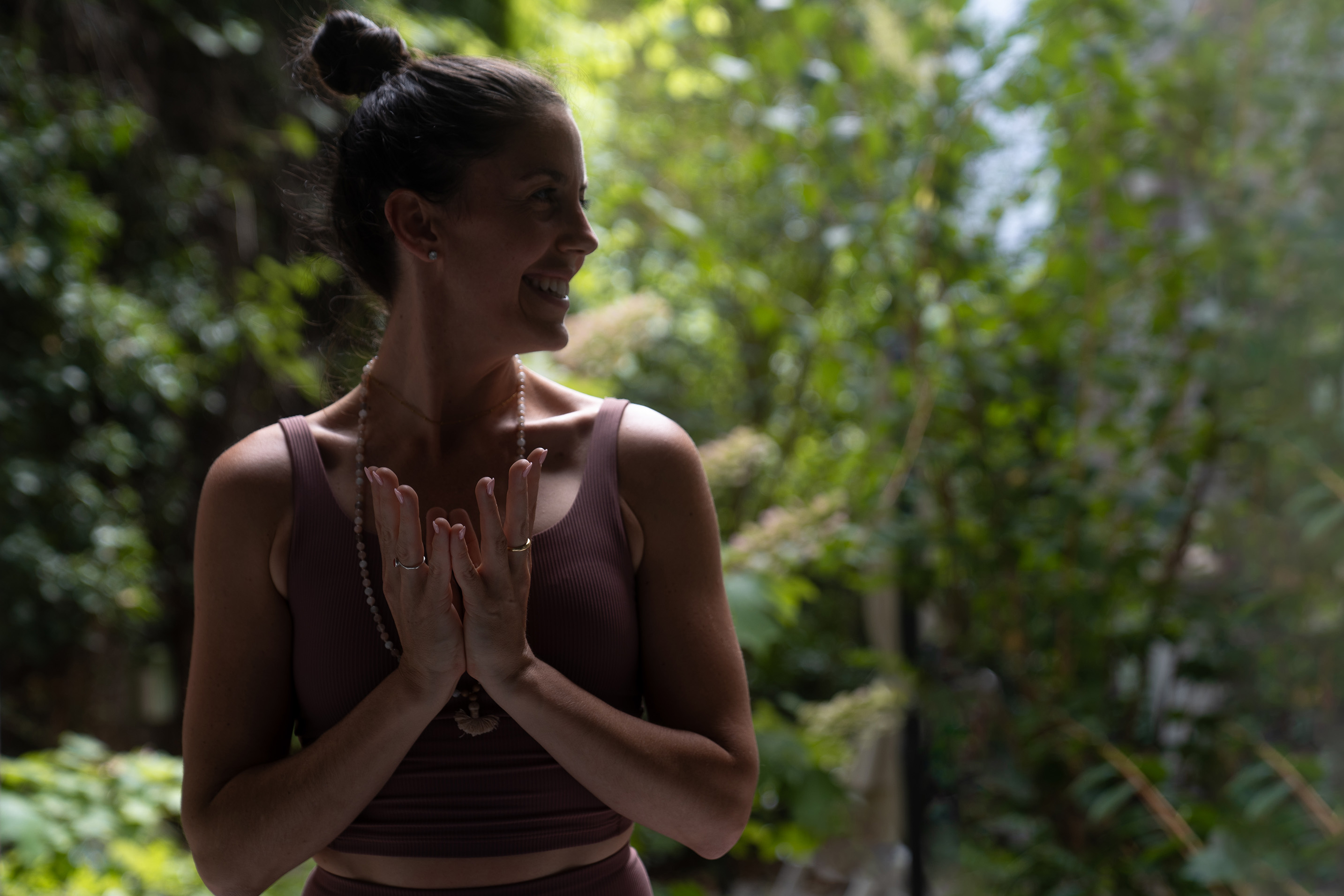 A serene, nature-filled scene with a yoga instructor in a mindful pose, surrounded by lush greenery—evoking calm, balance, and wellness.